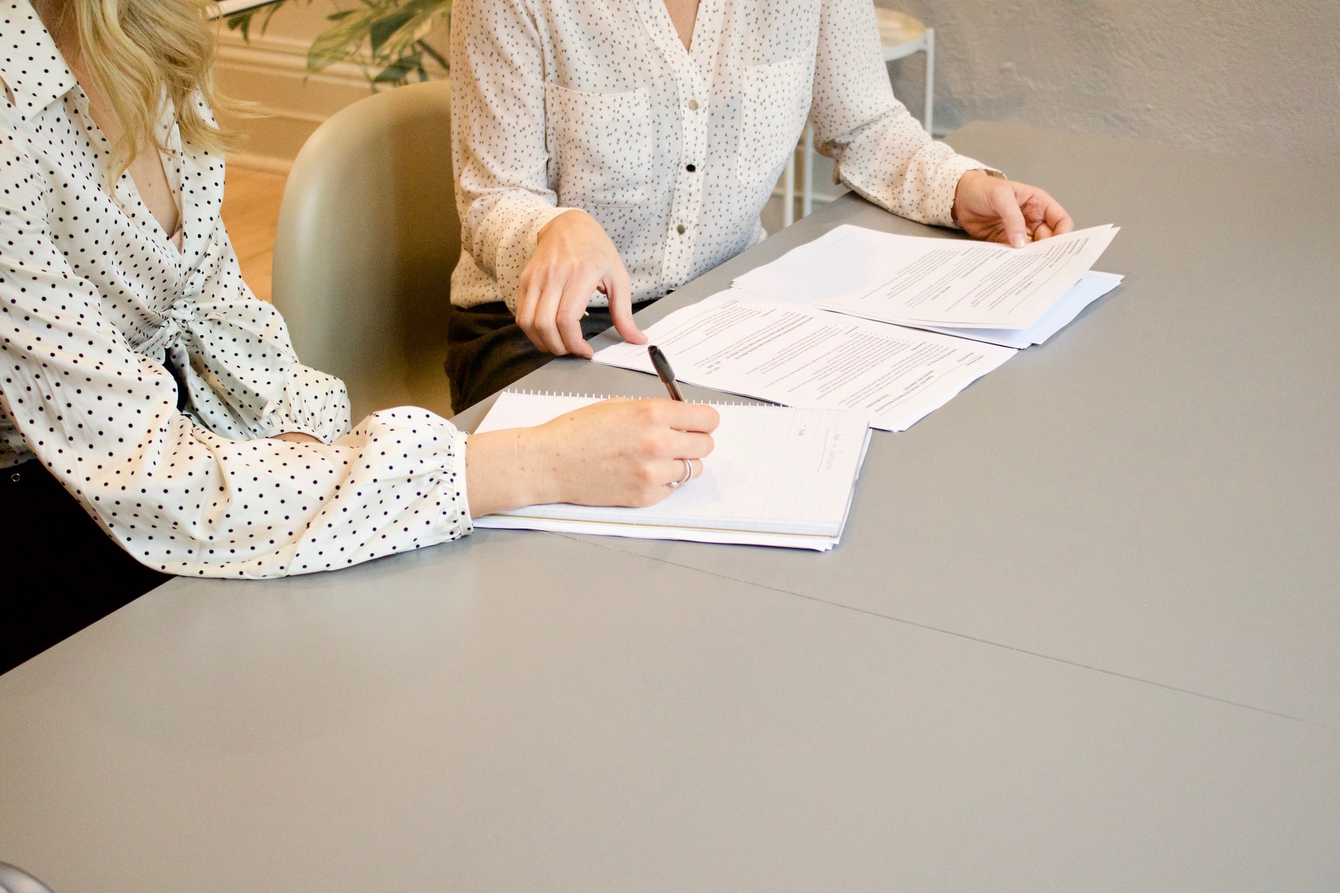 Women negotiating and signing agreement