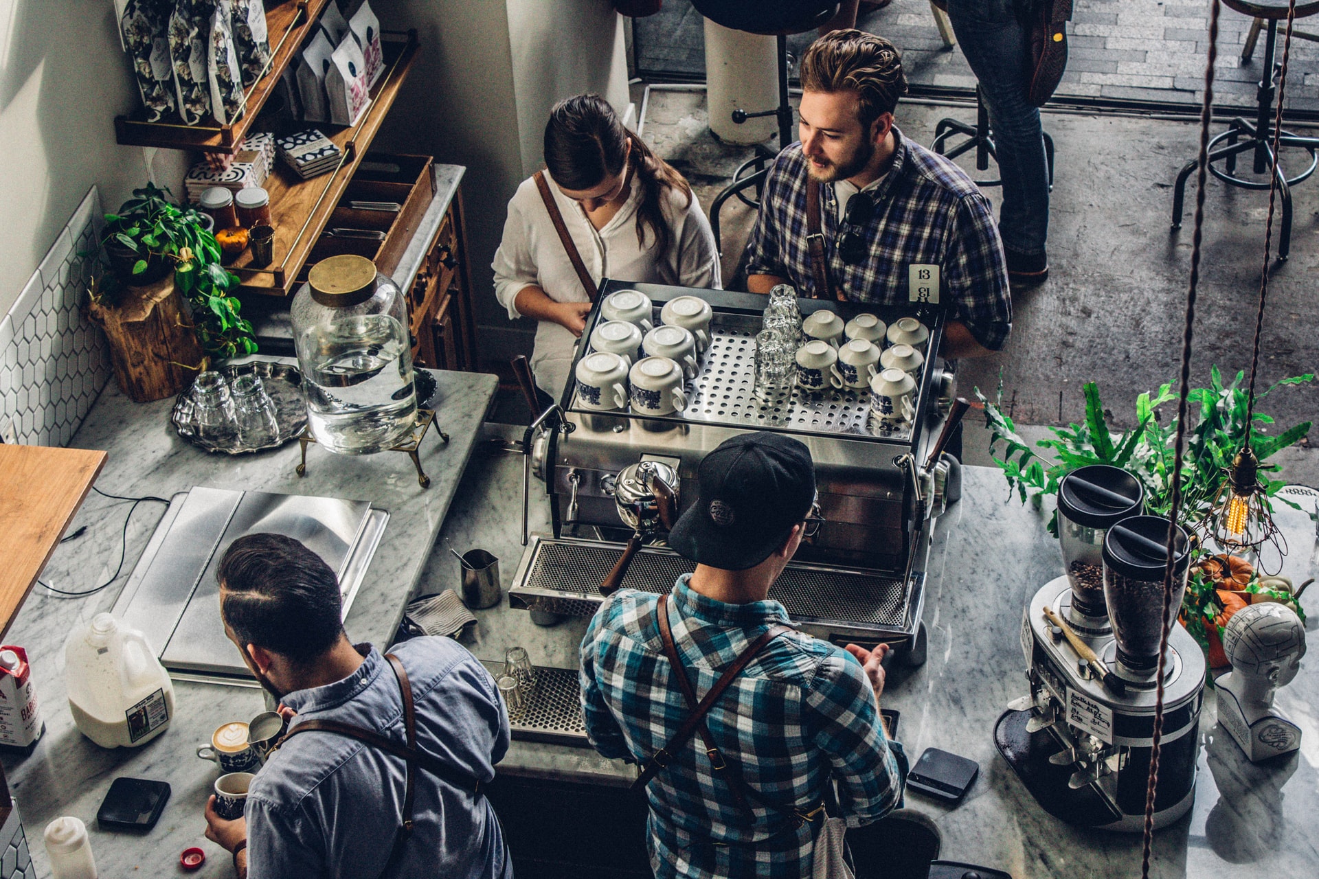 workers in a small cafe preparing coffee