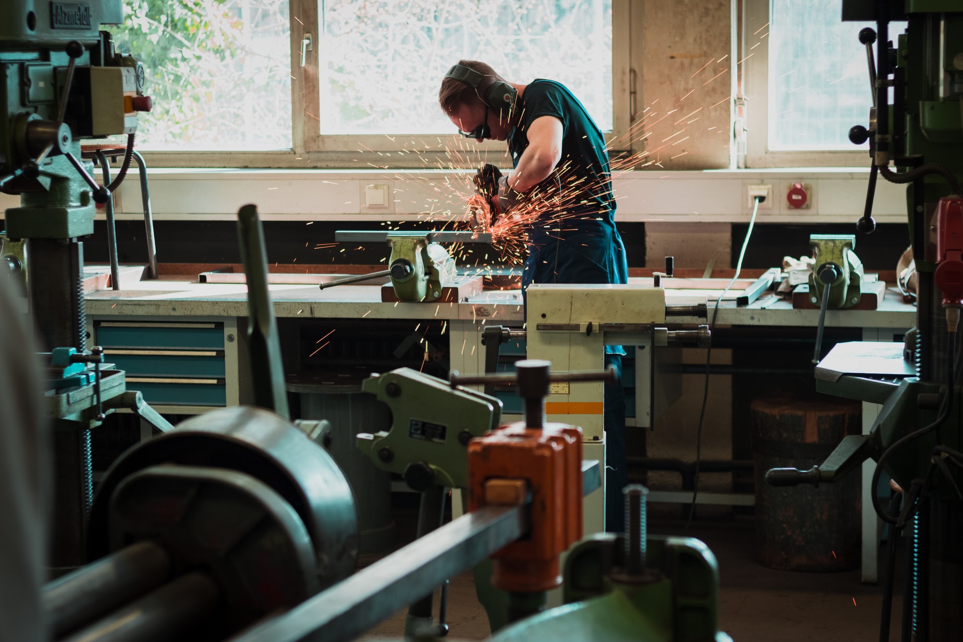 Man working hard grinding a piece of metal