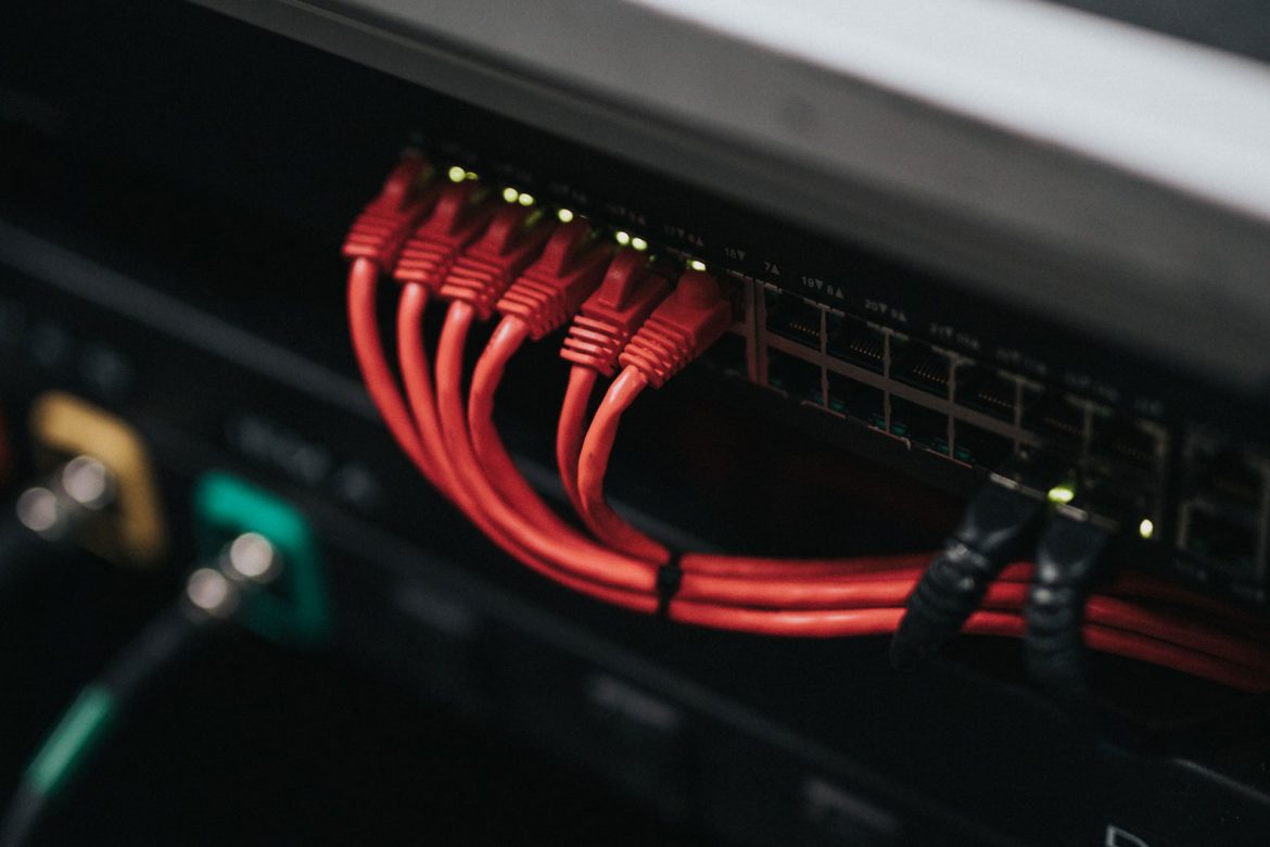 Black server rack with red cables