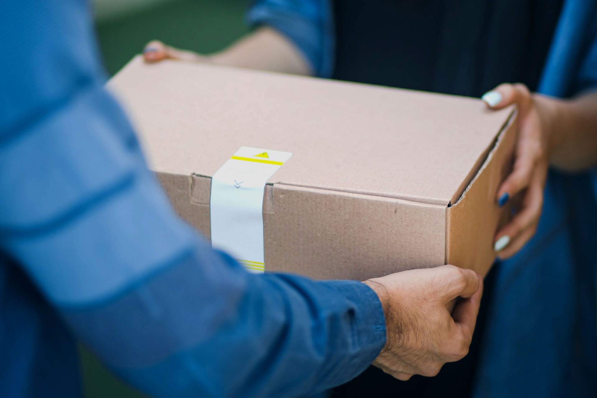 Person delivering brown box package