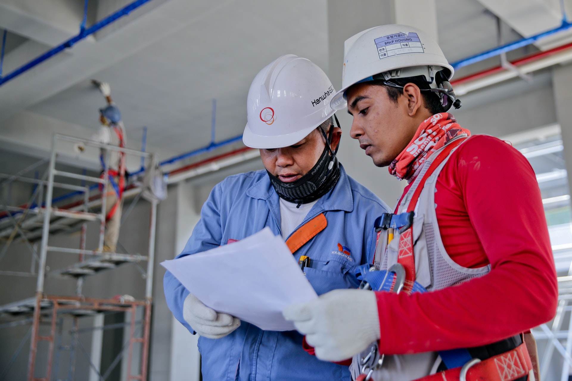 Two men at work with safety gear on